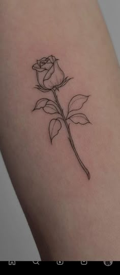 a single rose tattoo on the arm