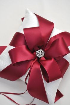 a red and white ribbon wrapped in satin