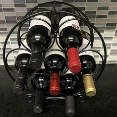 several bottles of wine are arranged in a circular rack