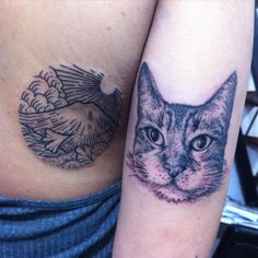 a close up of a cat on the side of a woman's stomach with an eagle behind it