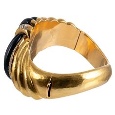 For Sale on 1stDibs - A substantial creation, rendered in 18 karat yellow gold with polished stokes of onyx knotted together with stripes of brilliant white diamonds. The stones Formal Yellow Gold Bangle With Black Enamel, Elegant Black Enamel Bracelet For Formal Occasions, Elegant Formal Black Enamel Bracelets, Elegant Polished Finish Bangle For Evening, Elegant Polished Bangle For Evening, Elegant Evening Bangle With Polished Finish, Elegant Black Enamel Bangle Bracelet, Elegant Formal Bangle With Black Enamel, Elegant Black Enamel Bangle