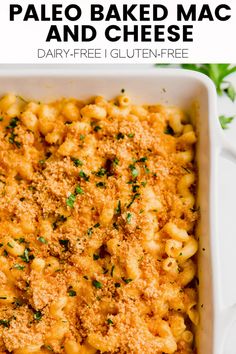 baked macaroni and cheese in a white casserole dish with parsley on top