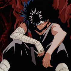 an anime character sitting on the ground with his hands behind his head and one arm wrapped around him