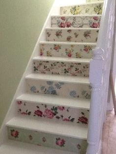 the stairs are decorated with floral wallpapers and painted with pink flowers on them