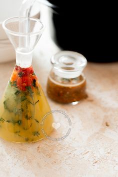 a blender filled with liquid sitting on top of a counter next to other items