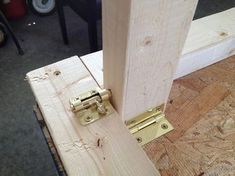 a close up of a door handle on a piece of wood with some screws