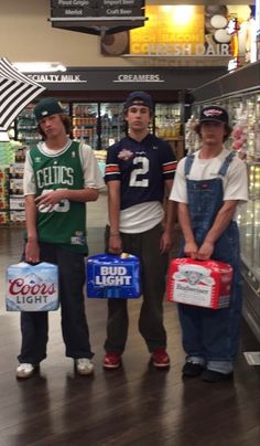 three people standing in a store holding coolers