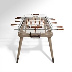 a foosball table with many pieces of wood and glass on it's legs