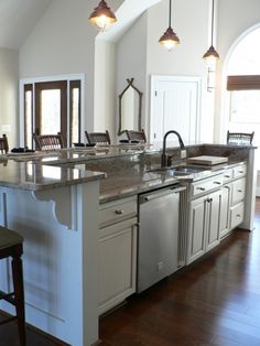 a large kitchen with an island in the middle