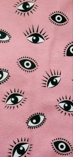 an eye pattern on pink fabric with black and white eyes in the center, all over