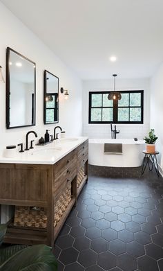 a bathroom with two sinks and a bathtub