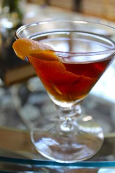 an orange peel garnish in a martini glass