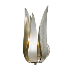 a metal sculpture with three curved shapes on it's sides, against a white background