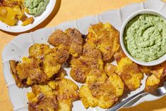 a plate with some fried food and a bowl of guacamole