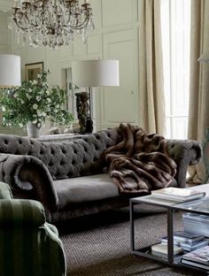 a living room filled with furniture and a chandelier