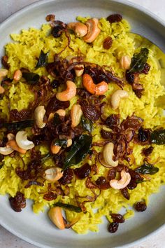 a white plate topped with rice and nuts