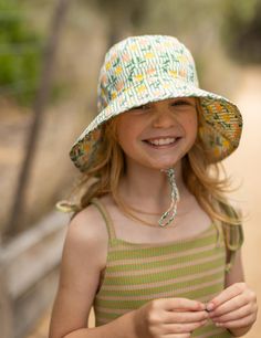 Bucket hat with a tulip floral print on outside and on the inner brim. Elasticated toggle around the head for the perfect fit. Cord and toggle under the chin to keep the hat in place. Wide brim (Measures for each size S: 6cm, M: 6.5cm, L: 7cm, XL: 7.5cm). Material: 100% Cotton including lining. Tested and certified as UPF50+ sun protection. Acorn Kids, Kids Sun Hat, Baby Bloomers, Baby Bundles, Tiny Cottons, Wool Beanie, Kids Boutique, Bucket Hats, Hats For Sale