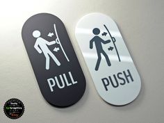 two black and white signs that say pull, push and man with stickers on them