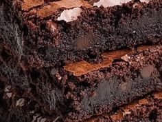 several pieces of chocolate cake stacked on top of each other