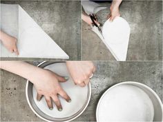 someone cutting paper with scissors in the shape of a heart on top of a white plate