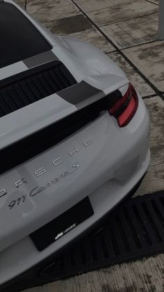 the rear end of a white porsche car