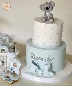 a baby shower cake with a koala bear on top