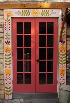 two red doors with flowers painted on them