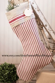 a christmas stocking hanging from the side of a wooden ladder with a tag on it