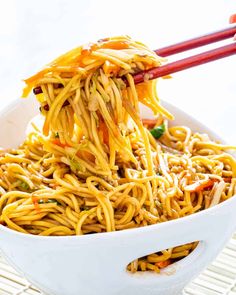 noodles with chopsticks in a white bowl