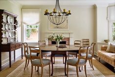 a dining room table with chairs and a chandelier