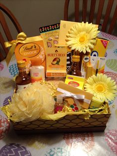 a gift basket filled with sunflowers and personal care items on top of a table