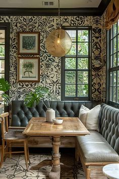 a living room with couches, tables and pictures hanging on the wall above them