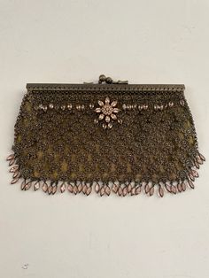 This is a one of a kind Kenny Ma designer clutch purse. It is hand tooled mesh in a burnt gold design with a silk lining, and decorated with hand set light pink Swarovski crystals.  It has a tight metal clasp. It has a Swarovski flower relief design on the front.  Kenny Ma has designed bags for celebrities for decades. The inside label  Reads Kenny Ma San Francisco, as does the attached key fob.  The purse measures 8 inches wide and 4 inches long. Perfect for a cell phone, lipstick, credit card holder.  It is from a smoke free home.It is in excellent brand new condition.  Truly a work of art!! Antique Style Evening Clutch Bag, Brown Embellished Evening Bag, Victorian Rectangular Evening Bag For Party, Handmade Victorian Evening Bag, Antique Clutch Evening Bag For Party, Antique Evening Clutch Bag, Victorian Rectangular Evening Bag, Designer Brown Clutch For Evening, Handmade Brown Evening Clutch