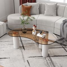 a living room with a couch, coffee table and two end tables on the floor