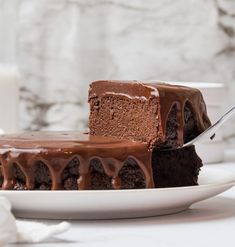 there is a piece of chocolate cake on the plate with a fork next to it