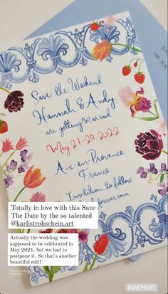 the wedding stationery is displayed on top of two envelopes, one with an image of flowers