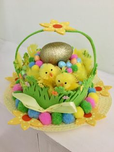 a basket filled with eggs and chicks sitting on top of a table