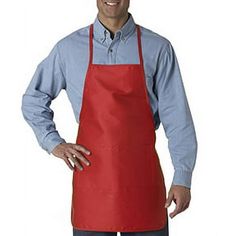 a man wearing an apron and smiling at the camera with his hands on his hips