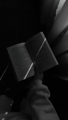 a person is reading a book in the dark