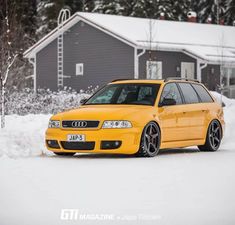 the yellow car is parked in the snow