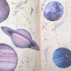 an open book with pictures of planets and stars on the pages that are drawn in pencil