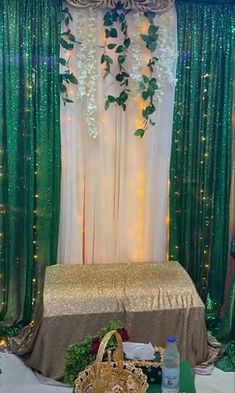 a decorated stage with green curtains and lights