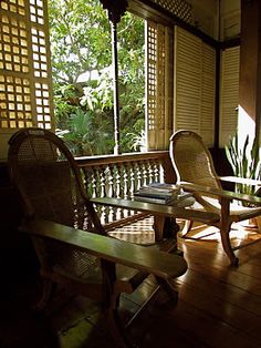 two chairs and a table on a porch