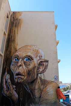 a painting of an old man on the side of a building