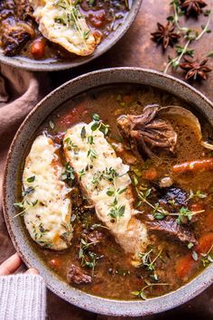 two bowls of stew with meat and vegetables