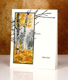 a white card with trees and leaves on it that says miss you in the center