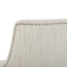 an upholstered chair with studding on the back