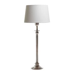 a silver lamp with a white shade on it