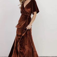 a woman wearing a brown velvet wrap dress