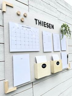 there is a calendar on the wall with notes attached to it